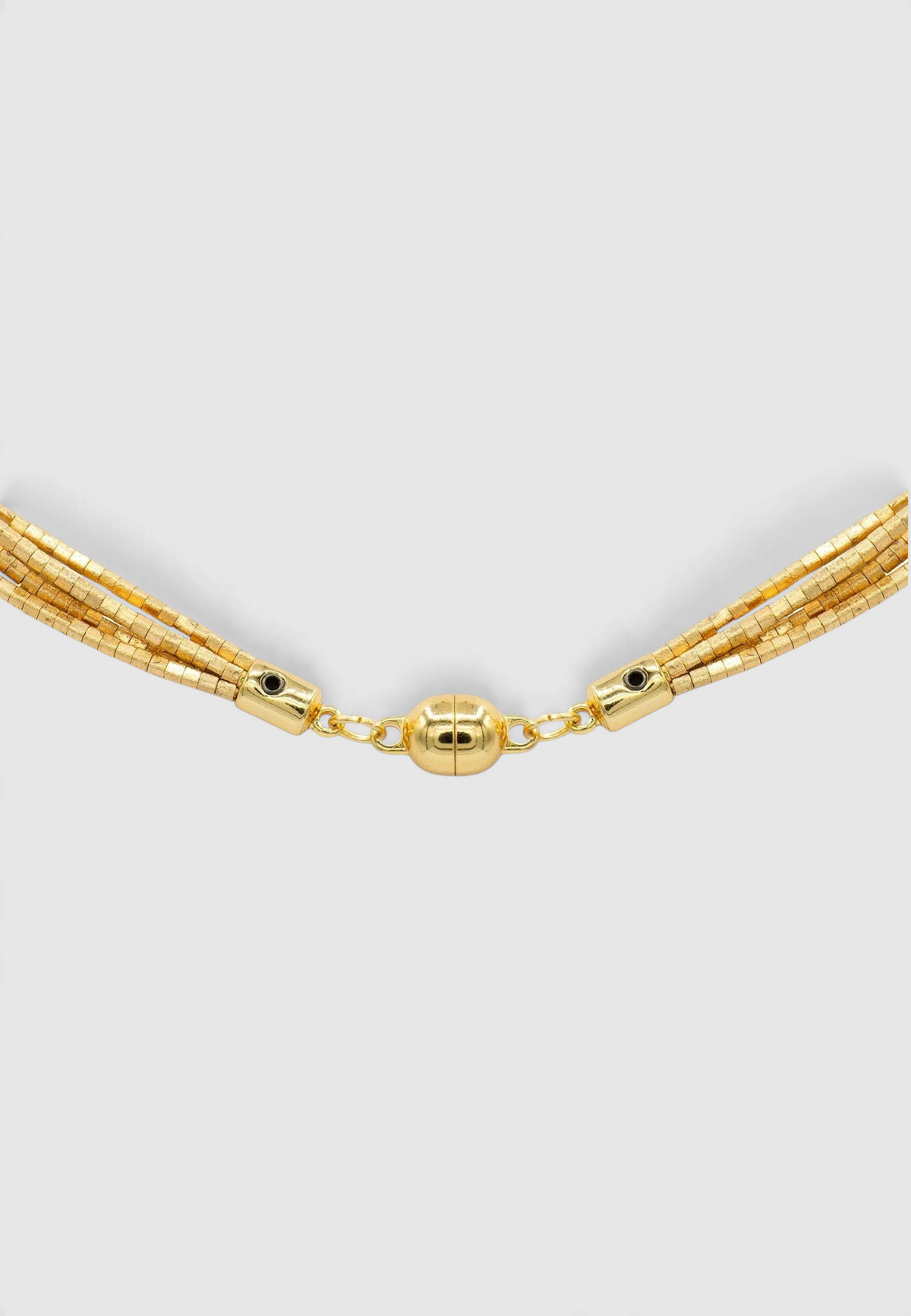 The Copper Shed Amunet 18k gold-plated multi-strand necklace with tiny cubic beads and a magnetic clasp.