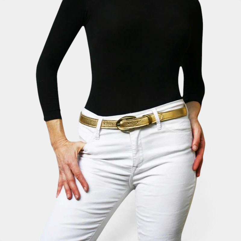 The Copper Shed thin gold leather belt with an etched antique brass buckle worn with white jeans