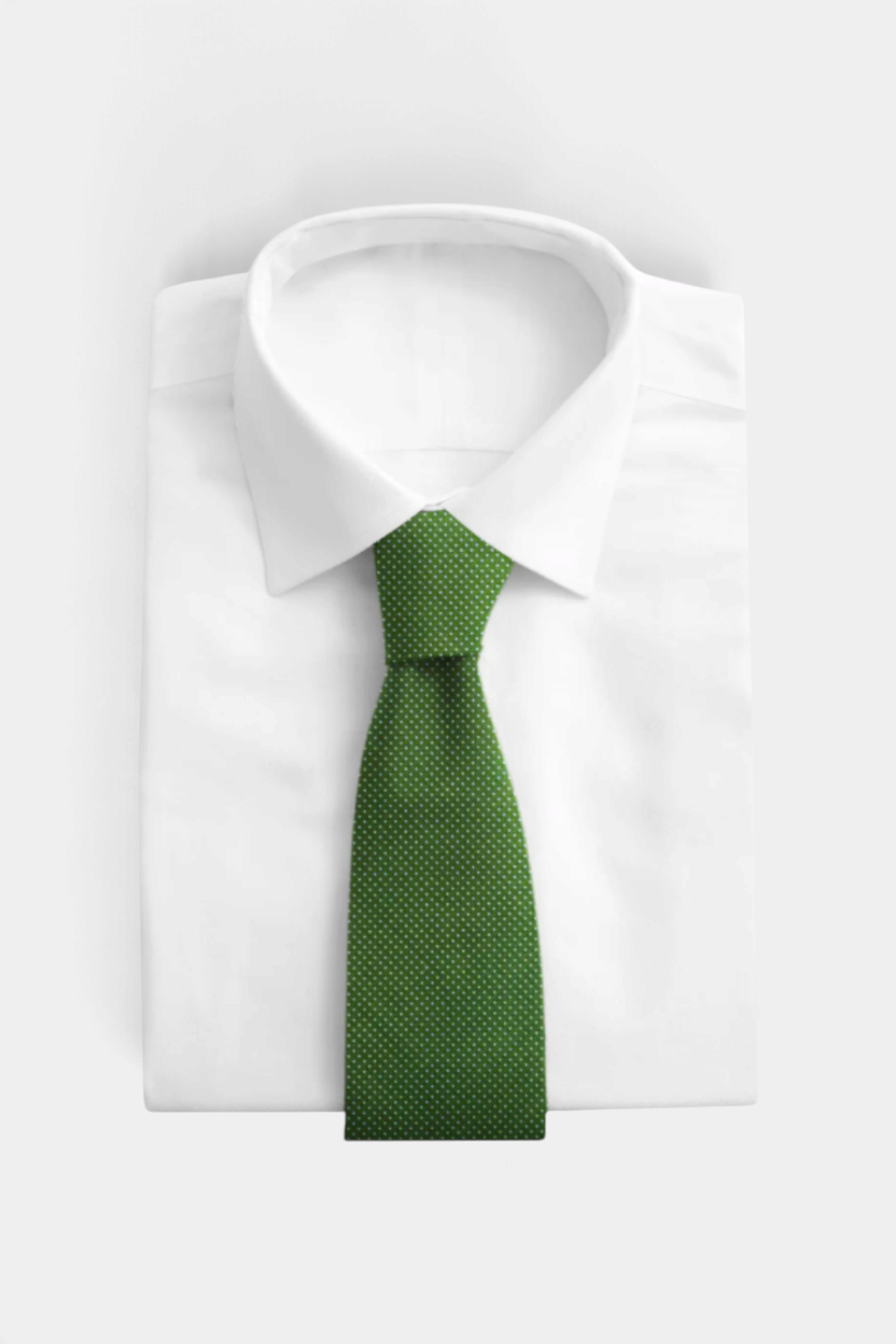 The Copper Shed green woven silk neck tie with white micro-dot pattern tied on a crisp white dress shirt