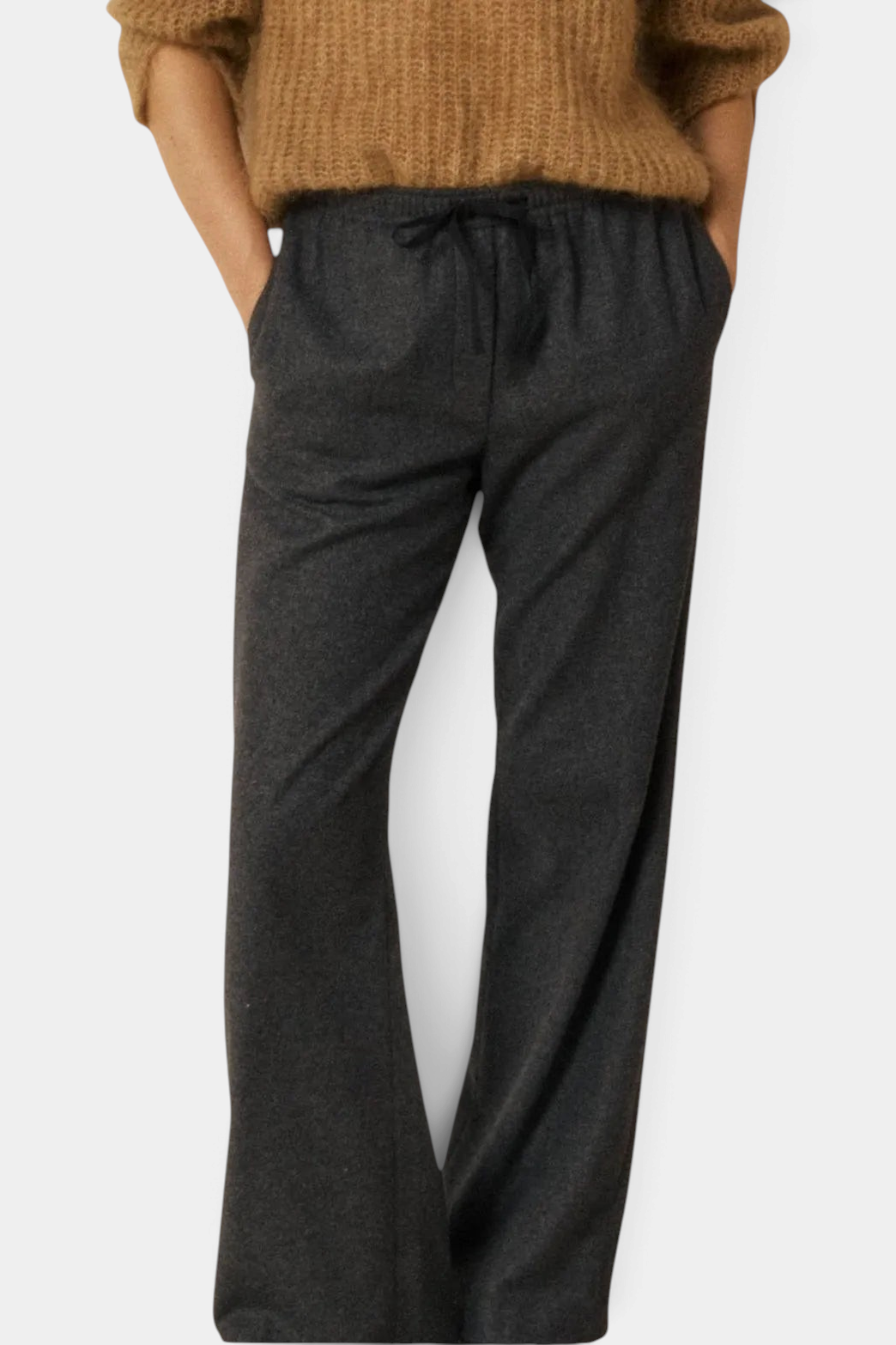 The Copper Shed Plumiel grey wool flannel pants with a wide leg, elastic drawstring waist, and side pockets.