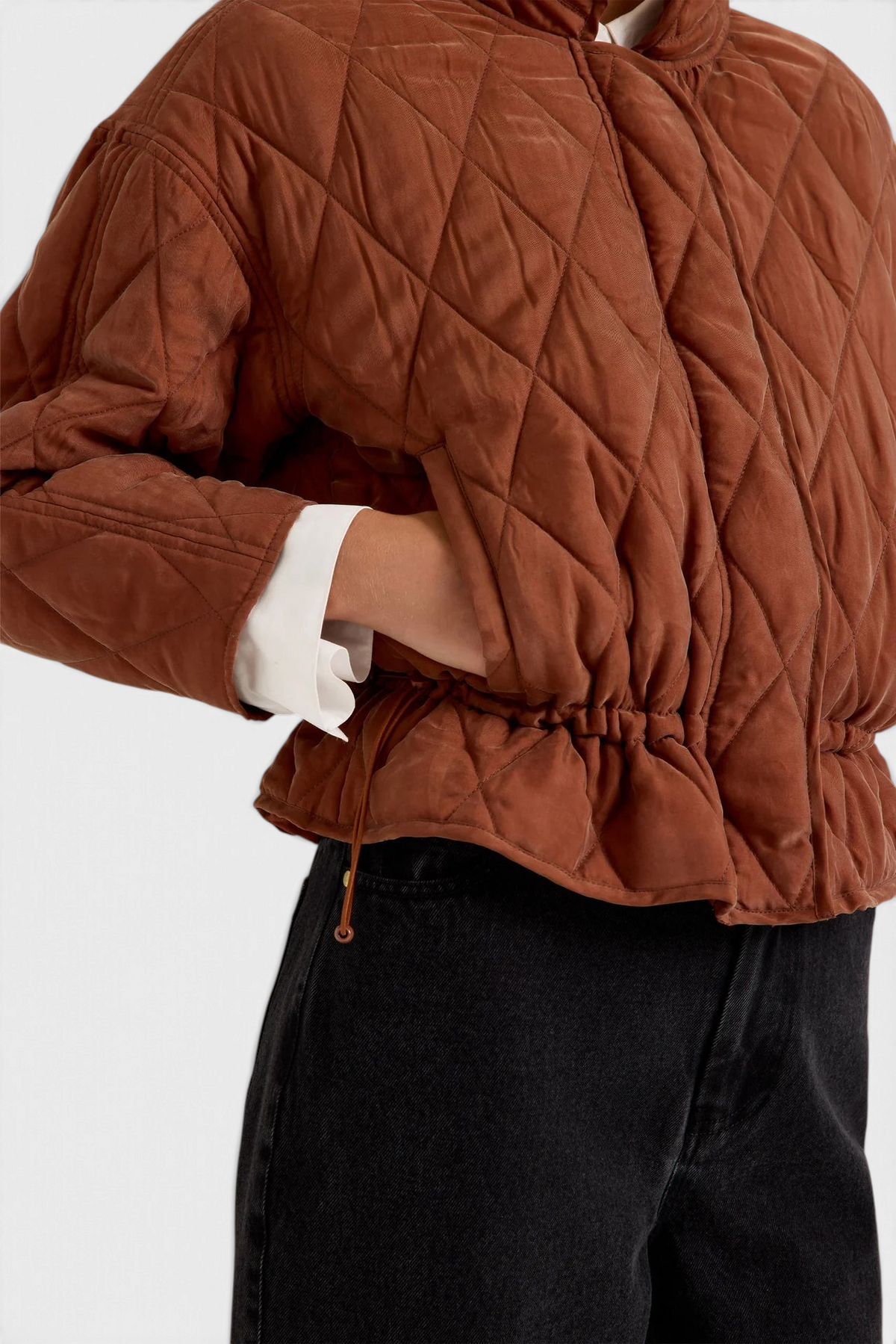 The Copper Shed Haisley quilted jacket in tortoise brown with a funnel neck and adjustable drawstring waist.