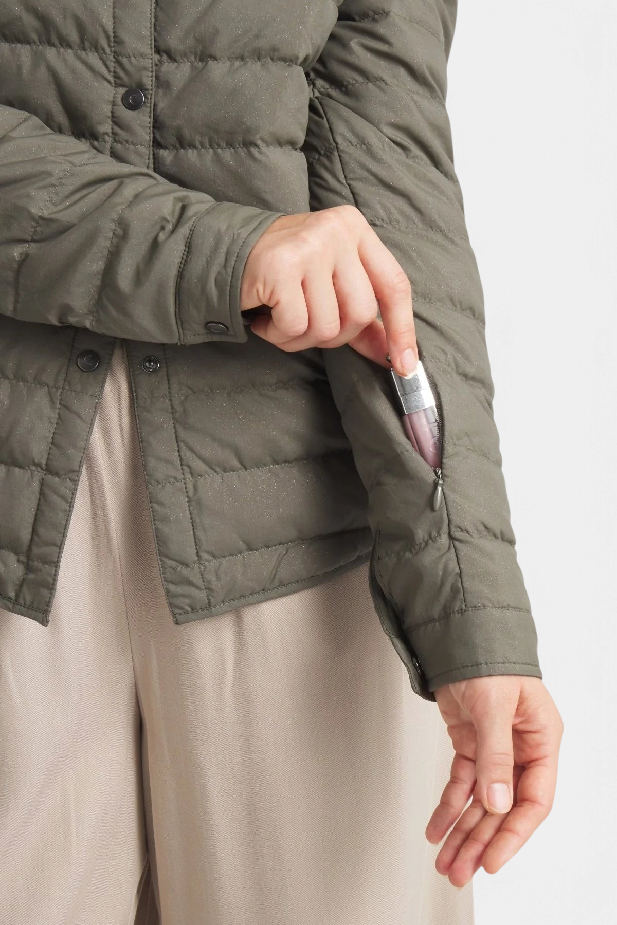 The Copper Shed Harrow matte olive green down shirt featuring a convenient zippered sleeve pocket for small items.