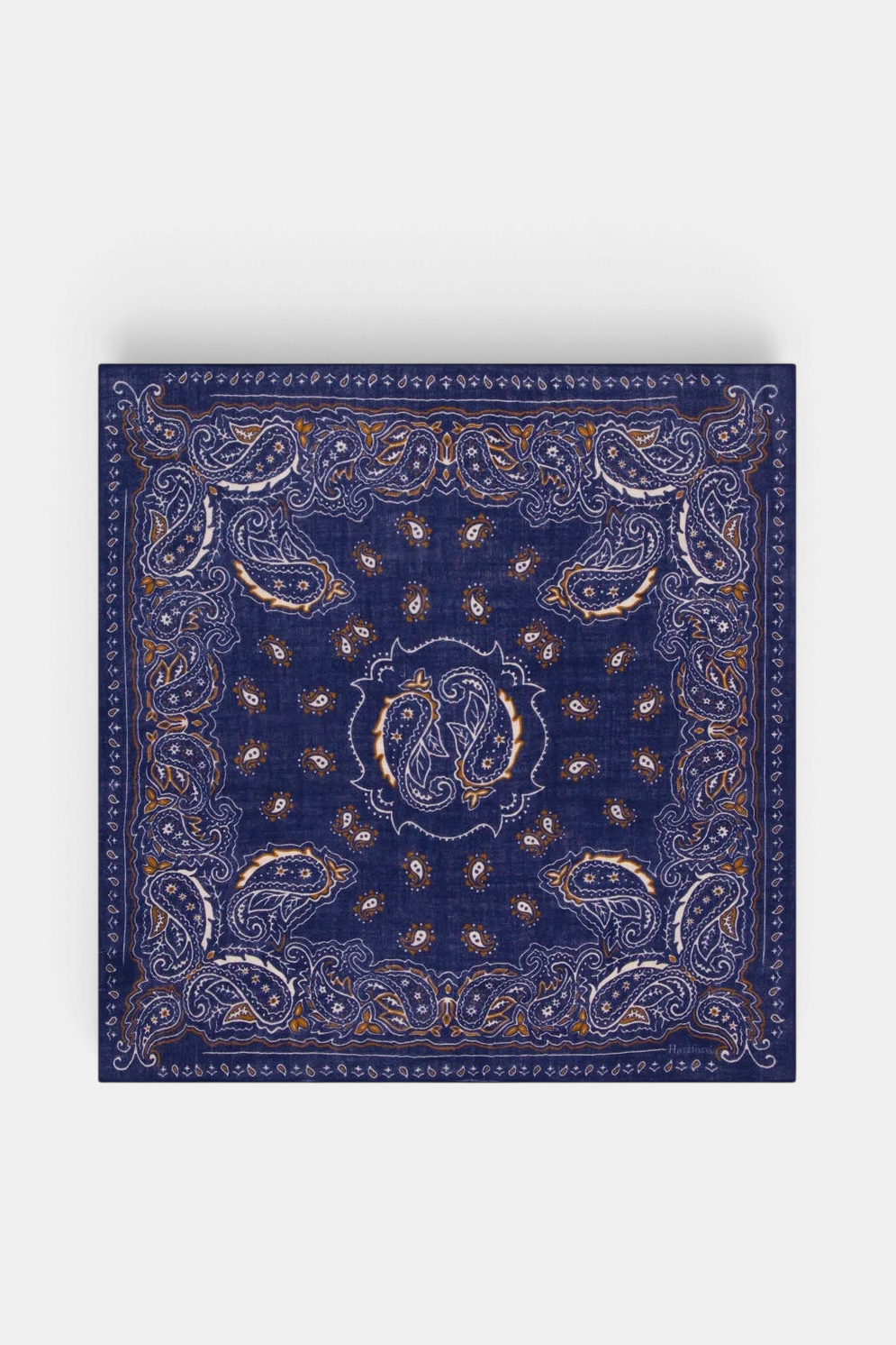 The Copper Shed Hartford blue wool bandana featuring a detailed white and brown paisley pattern in a square shape.