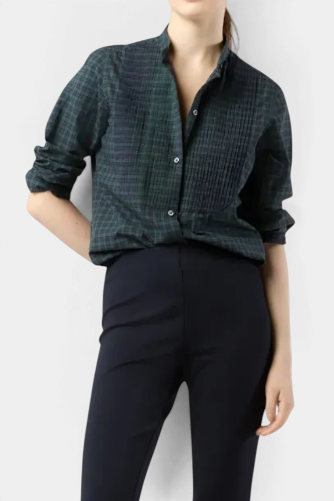 The Copper Shed Hattie shirt in Blackwatch tartan featuring a pleated bib-front, mandarin collar, and long sleeves.