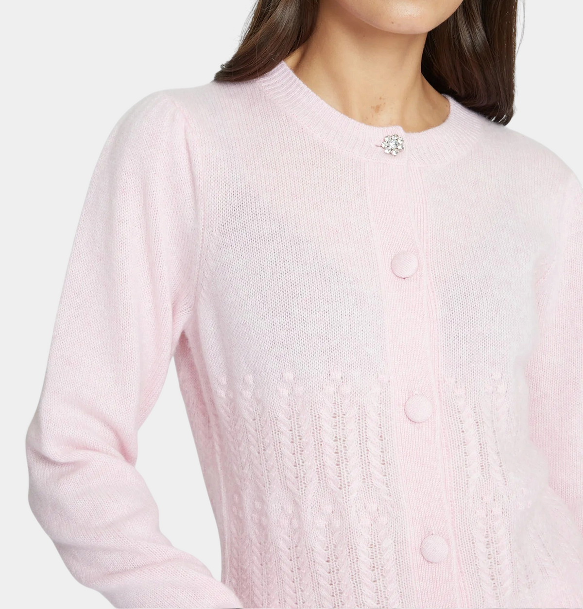 The Copper Shed heather pink cashmere cardigan with popcorn stitch, puff sleeves, and a crystal button crew neck.