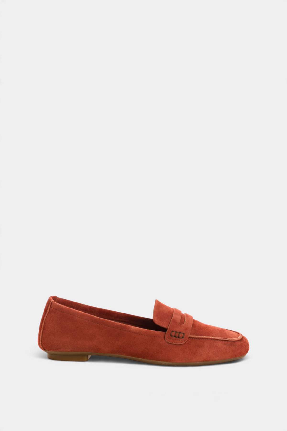 The Copper Shed Hema suede moccasin loafers in rust orange with a low 1cm heel and classic penny strap detail.