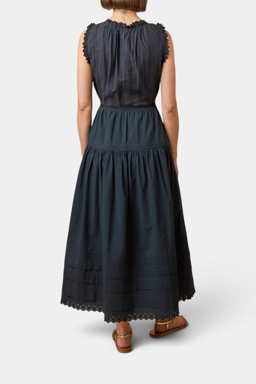 Back view of The Copper Shed Hortense Dress in dark organic cotton poplin with pintucks and scalloped lace trim.