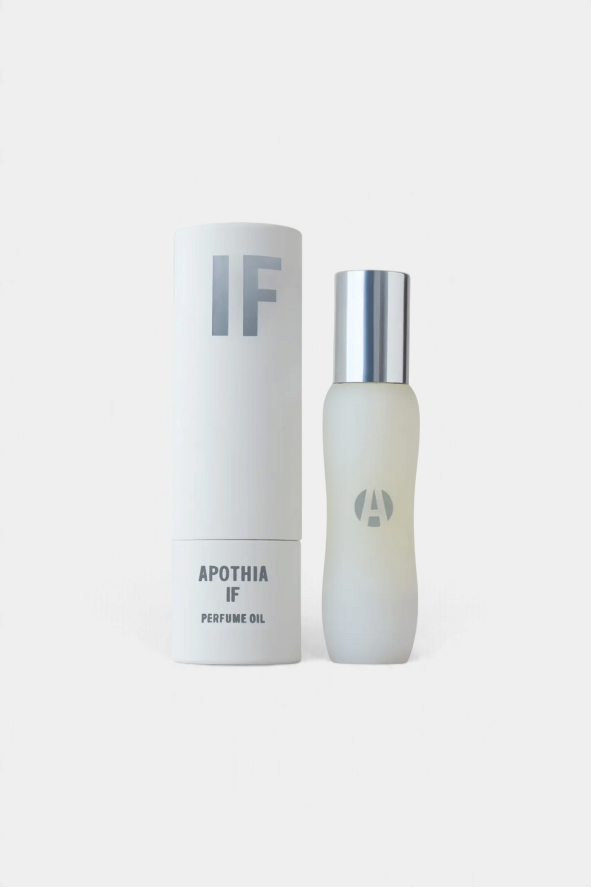 The Copper Shed IF perfume oil in a frosted glass bottle with a silver cap next to its white cylindrical box.
