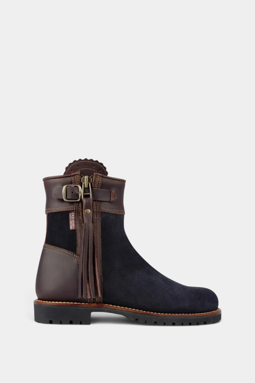 The Copper Shed Inclement cropped tassel boot in navy suede and brown leather with a rugged mountain tread sole.