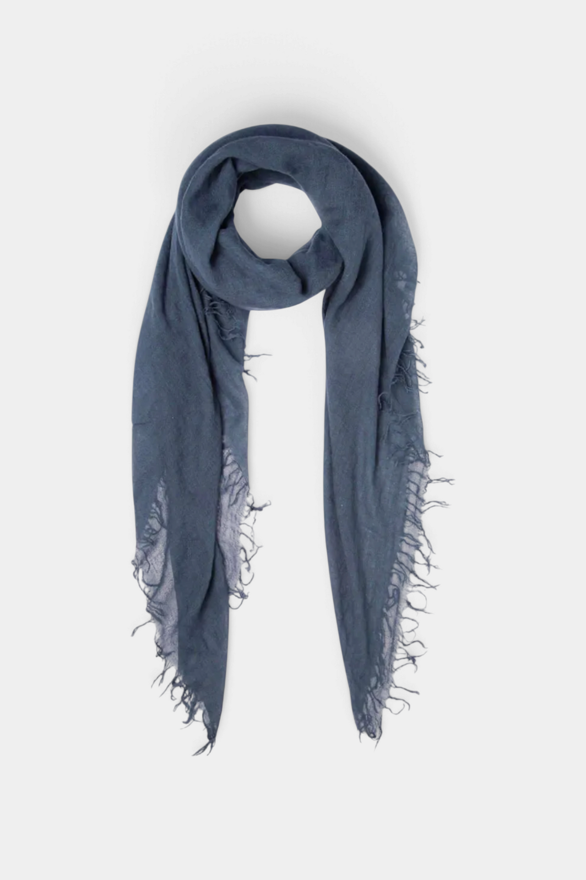 The Copper Shed indigo cashmere and silk blend scarf with delicate fringe trim edges on a neutral background.
