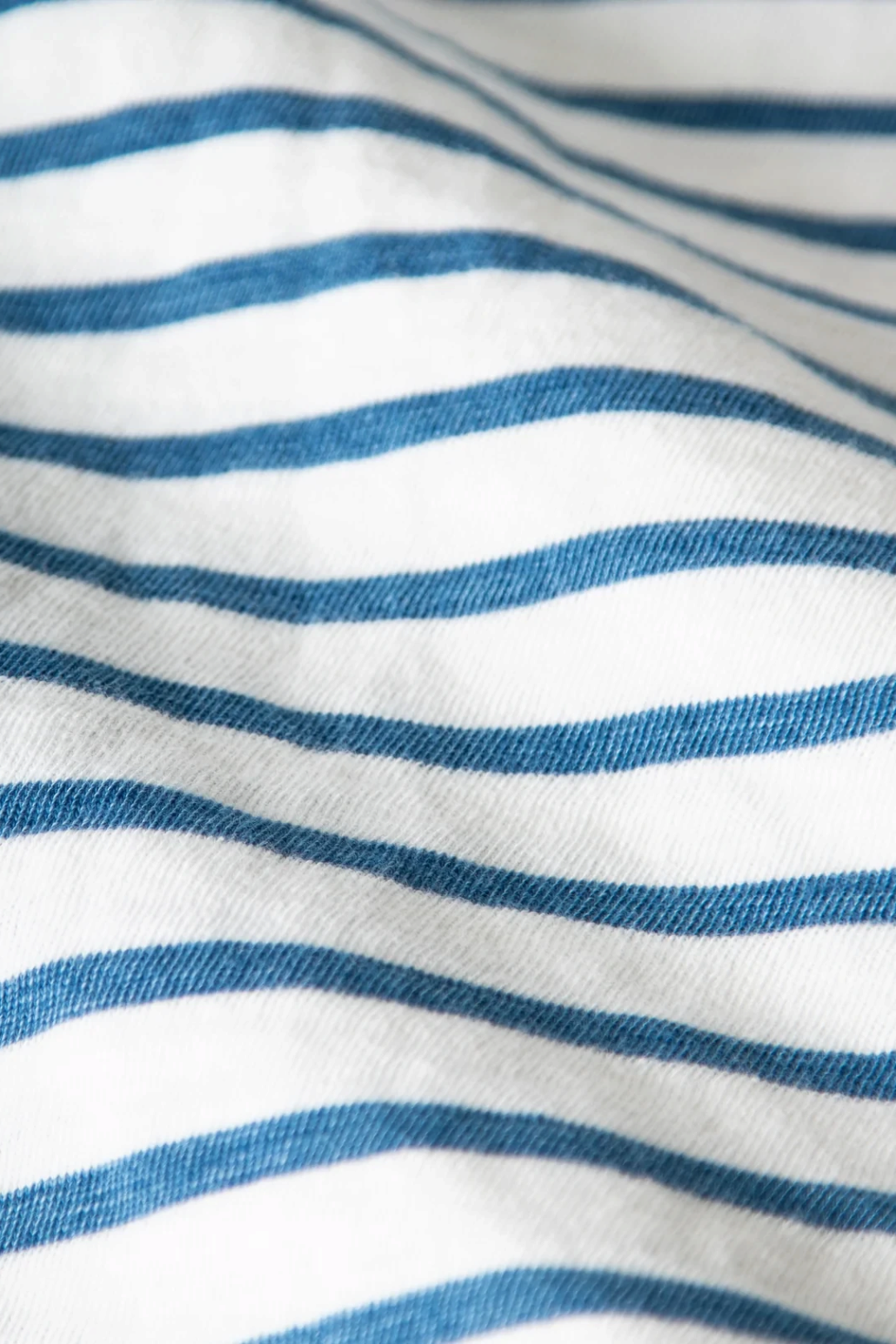 The Copper Shed long sleeve polo shirt fabric featuring a weathered indigo and white striped cotton pattern.