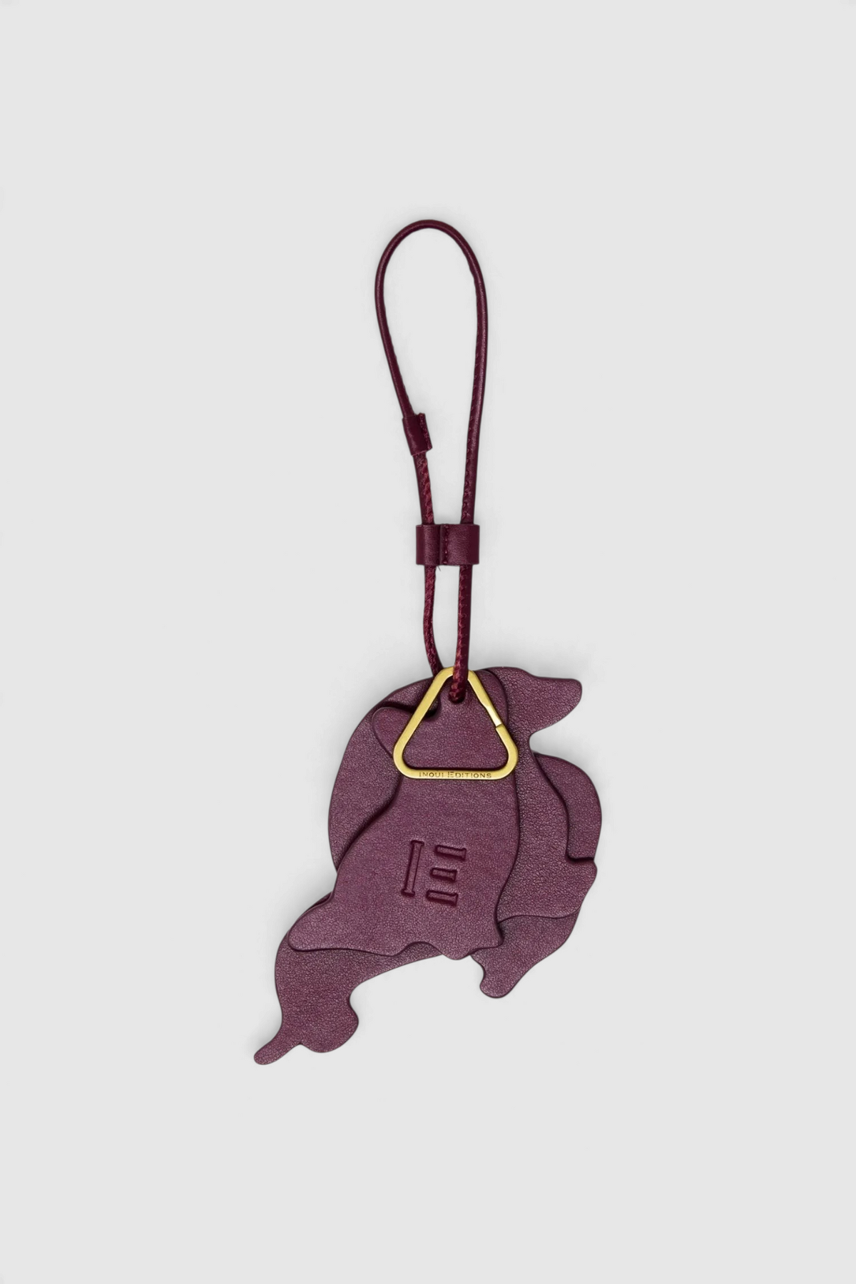 The Copper Shed Inoui Keychain Toutou in deep purple Italian leather with a gold-tone triangular ring attachment.
