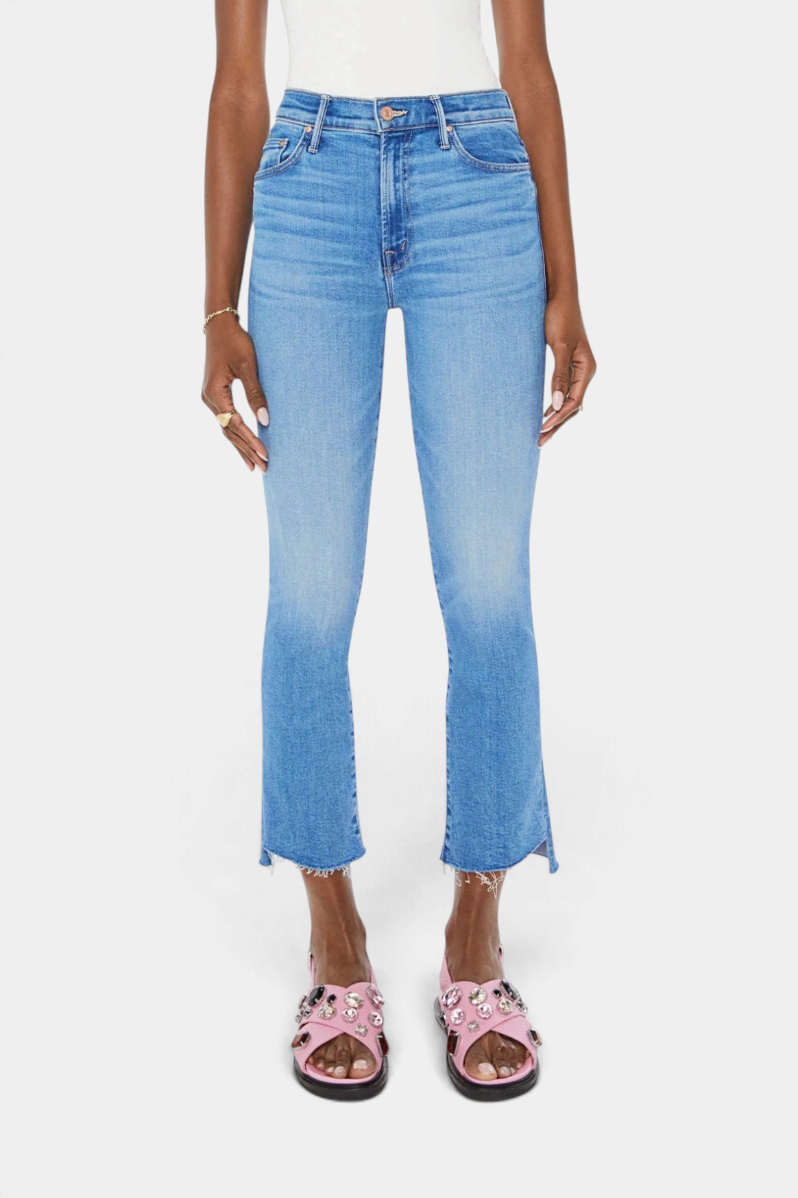The Copper Shed Insider Crop Step Fray blue denim jeans featuring a high-waisted bootcut fit and frayed step-hem.