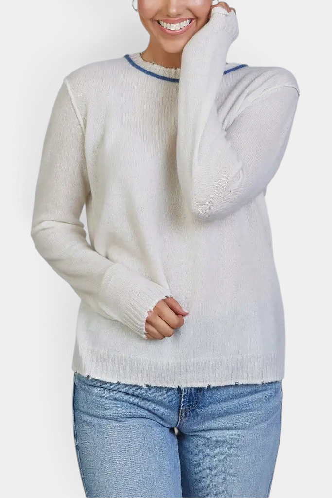 The Copper Shed ivory Mongolian cashmere sweater featuring a blue contrast crew neckline and raw edge detailing.