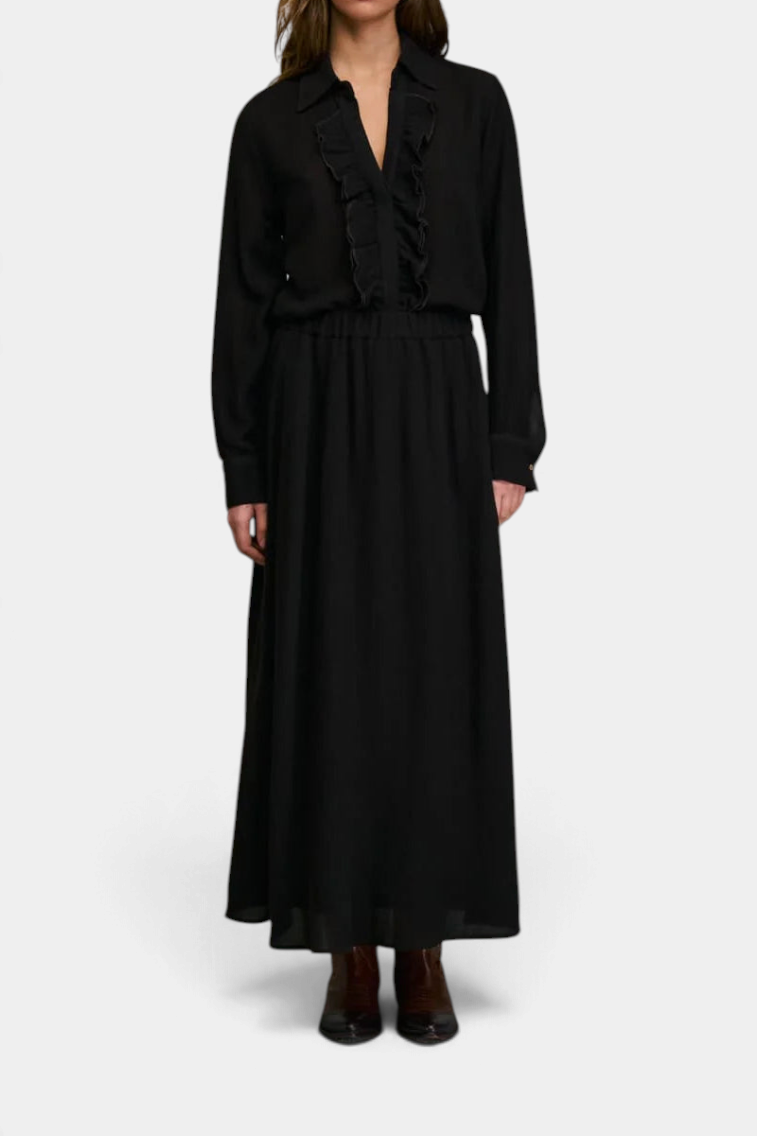 The Copper Shed Jabo Skirt in black, a long flowing maxi skirt paired with a matching ruffled blouse.