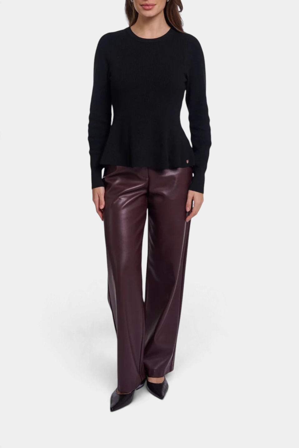The Copper Shed Jelilah black viscose-blend knit pullover with a round neck, long sleeves, and a flared peplum hem.