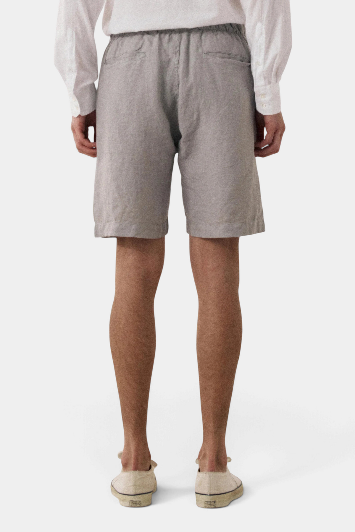 The Copper Shed Joggy shorts in grey cotton with an elasticated drawstring waist, back view on a model.