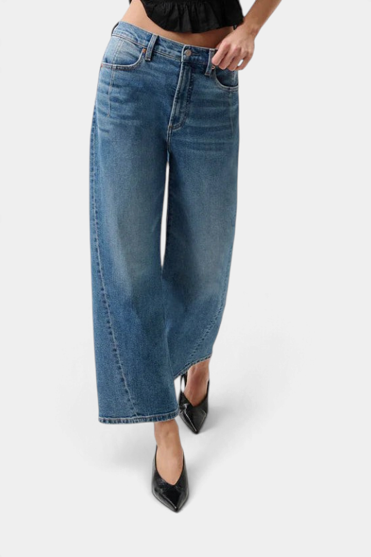 The Copper Shed Kyra high rise jeans in a light vintage wash with a bowed leg silhouette and cropped ankle length.