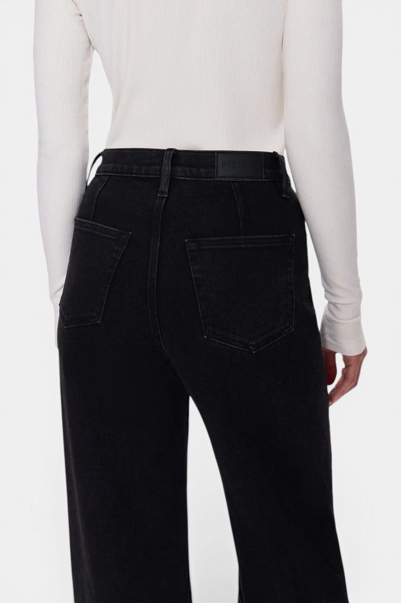 The Copper Shed Kyra high rise black denim jeans featuring back yoke seams and a fitted waistband, rear view.