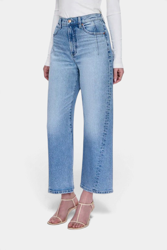 The Copper Shed Kyra high rise jeans in a light vintage wash with a bowed leg silhouette and cropped ankle length.
