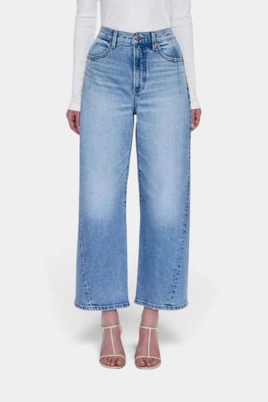 The Copper Shed Kyra high rise jeans in a light vintage wash with a bowed leg silhouette and cropped ankle length.