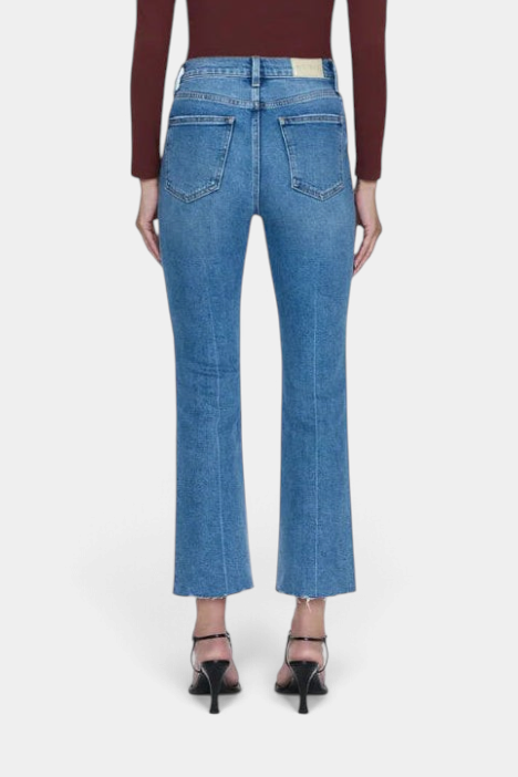 The Copper Shed Lennon high rise crop boot jeans in blue comfort-stretch denim with a raw hem, back view.