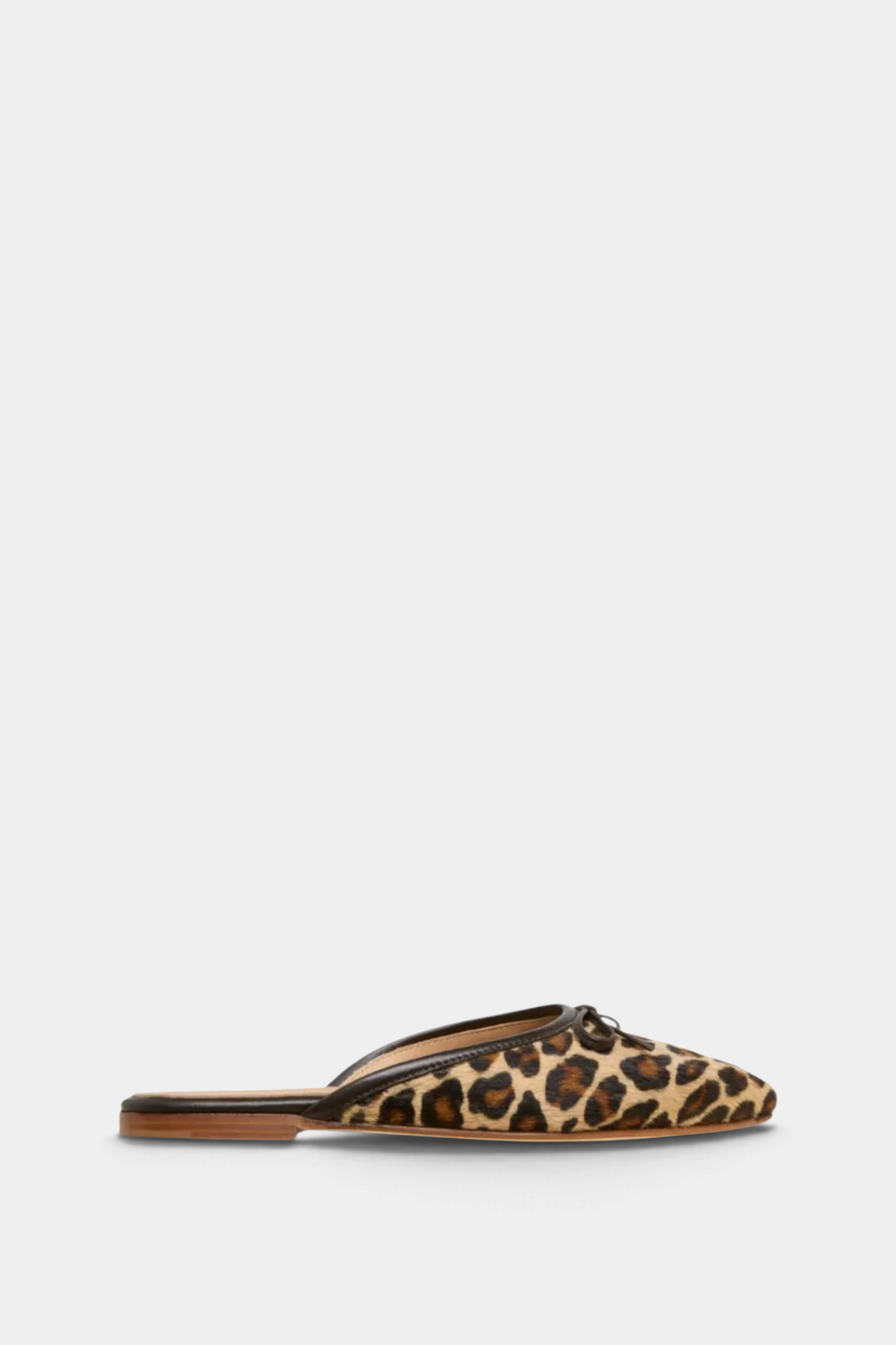 The Copper Shed Joy Mule in leopard print calf hair with a leather bow and almond toe, side view.