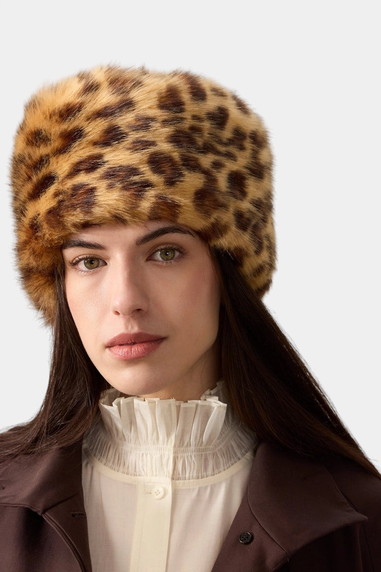 The Copper Shed leopard print faux fur pillbox hat worn by a woman with dark hair against a neutral background.