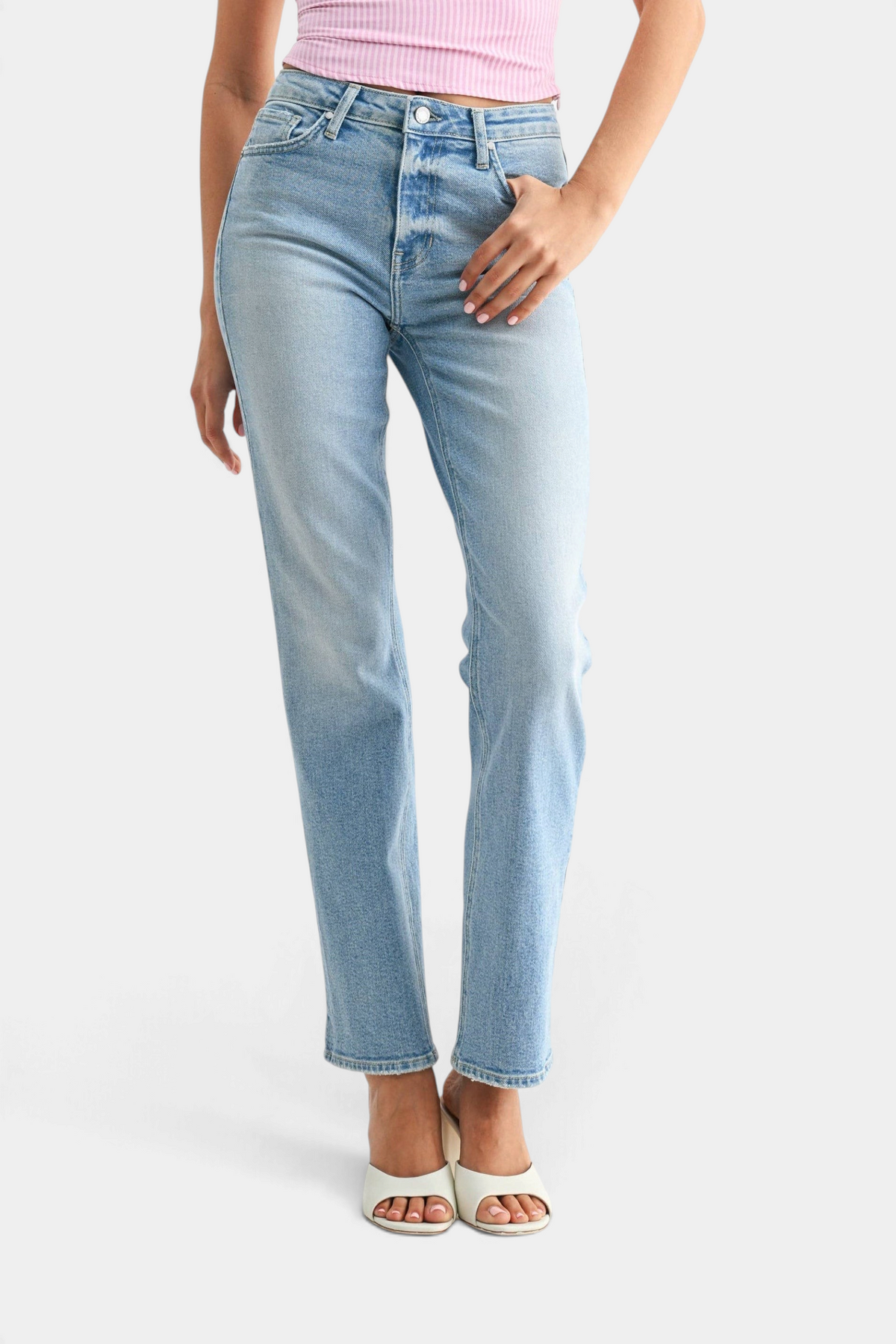 The Copper Shed mid-rise stovepipe straight leg jeans in light wash denim worn by a model with white heeled sandals.