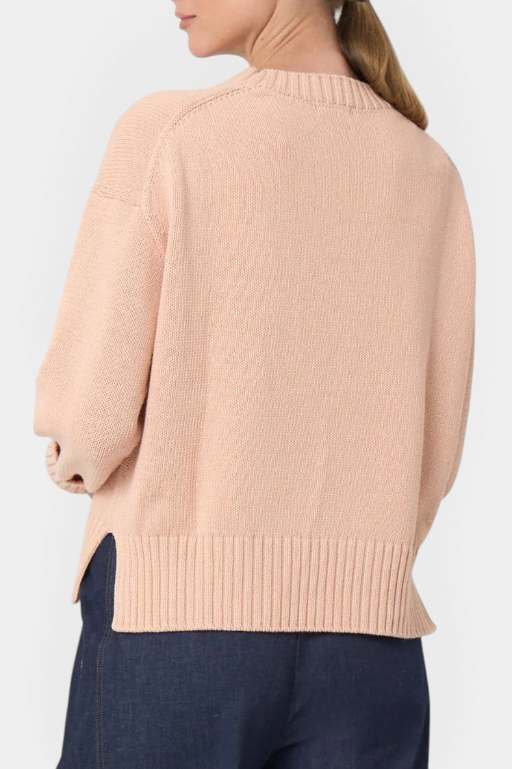 The Copper Shed Logan cotton crewneck sweater in blush pink with a high-low hem and wide ribbed cuffs, back view.