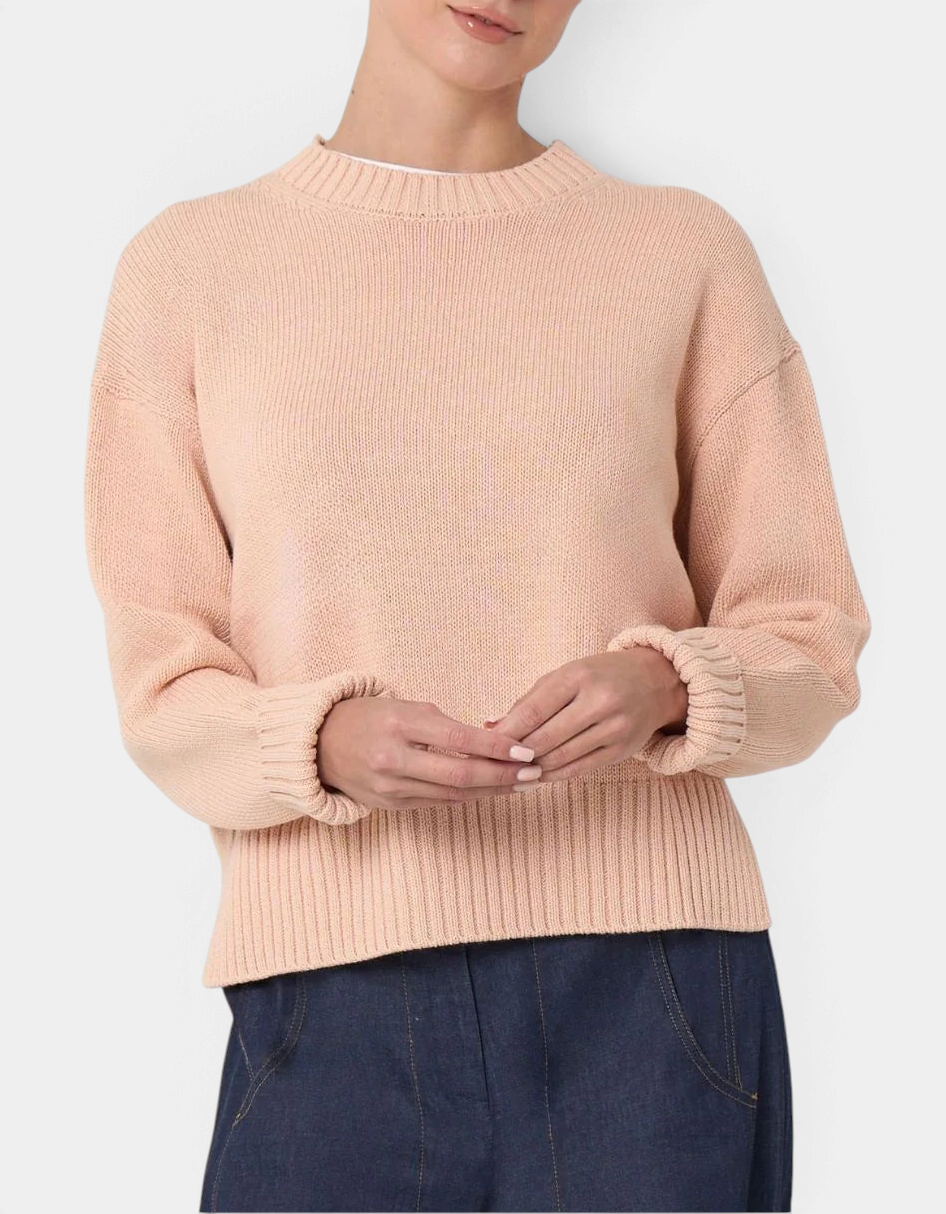 The Copper Shed Logan cotton crewneck sweater in peach with a relaxed fit, high-low hem, and wide ribbed cuffs.