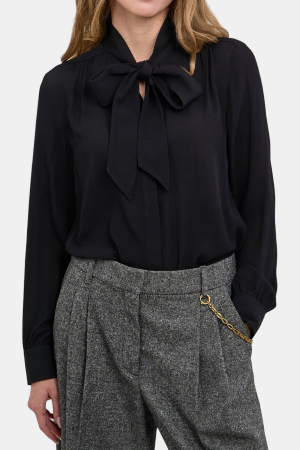 The Copper Shed Louise black viscose blouse with a self-tie bow neck, long sleeves, and button cuffs.