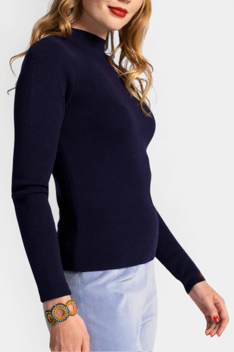 The Copper Shed Marie long sleeve navy blue mock neck sweater in rib knit cotton worn by a model