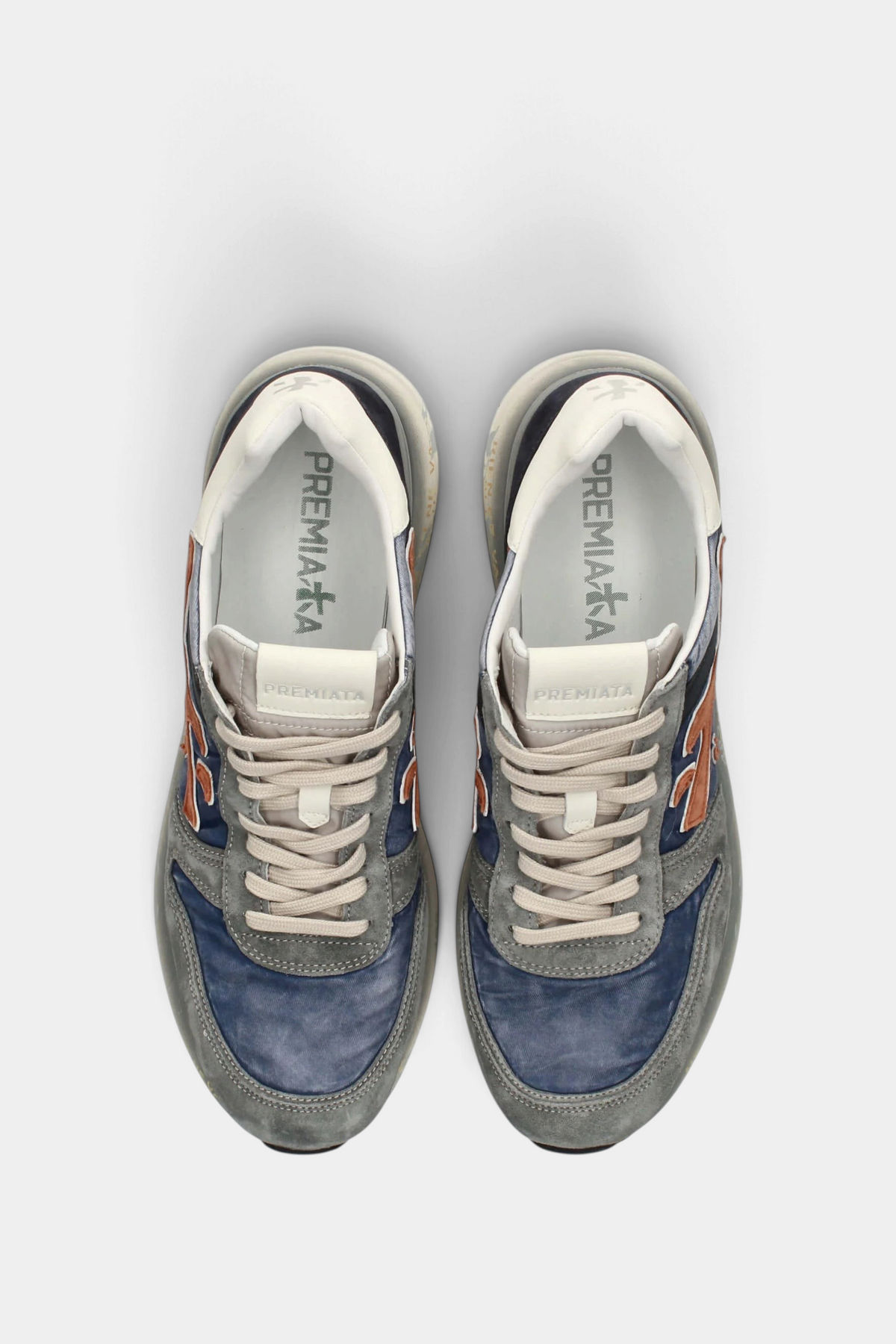 The Copper Shed Mick 7215 sneakers in blue and grey suede with orange logo accents and a vintage-effect sole.