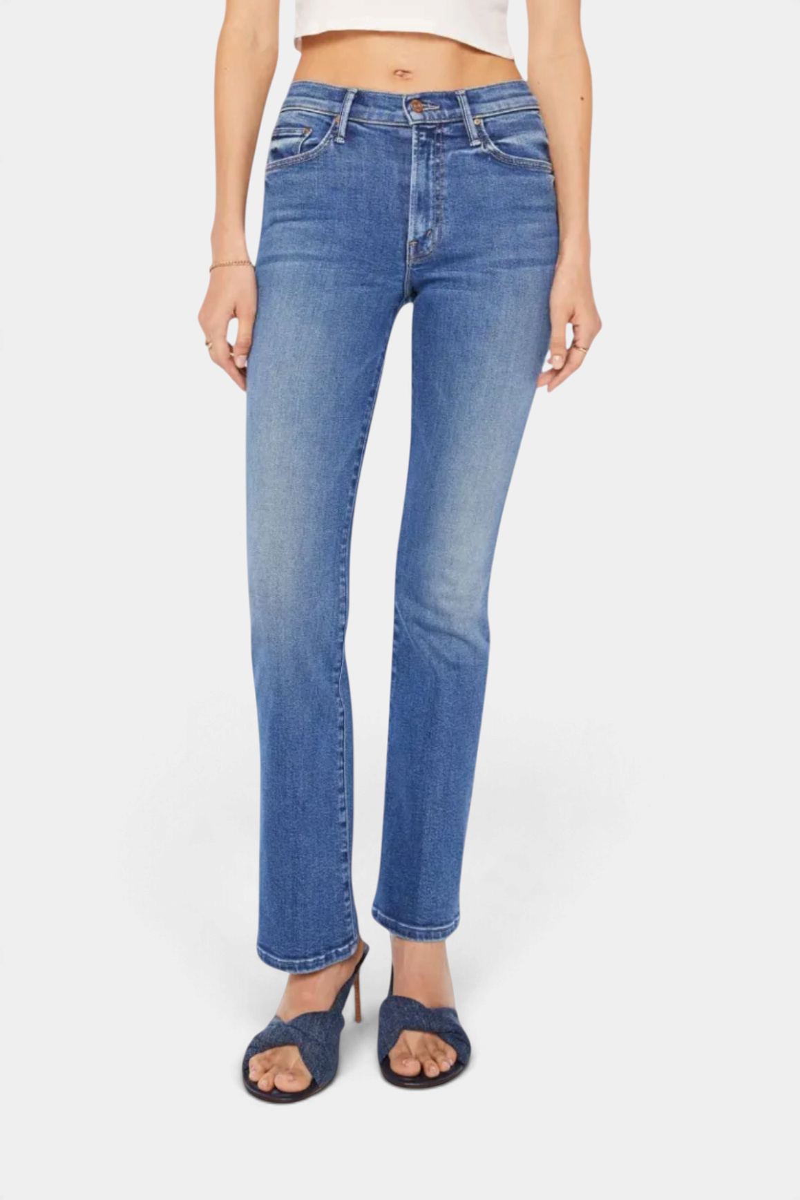 The Copper Shed mid-rise stretch denim jeans in mid-blue with whiskering and a narrow flare leg fit.