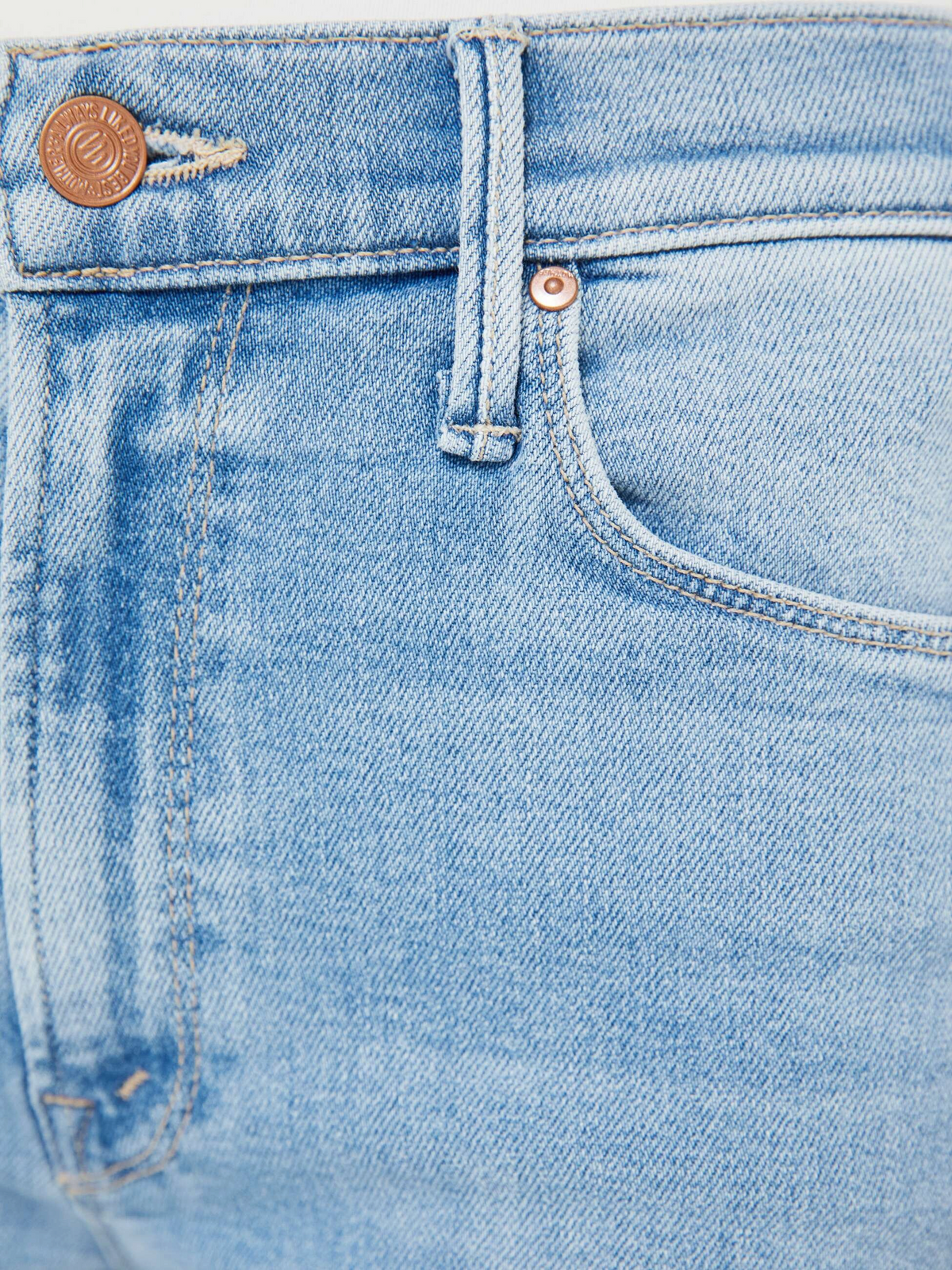 The Copper Shed Mid Rise Dazzler Ankle jeans in light blue denim with copper-toned hardware and zip fly detail.