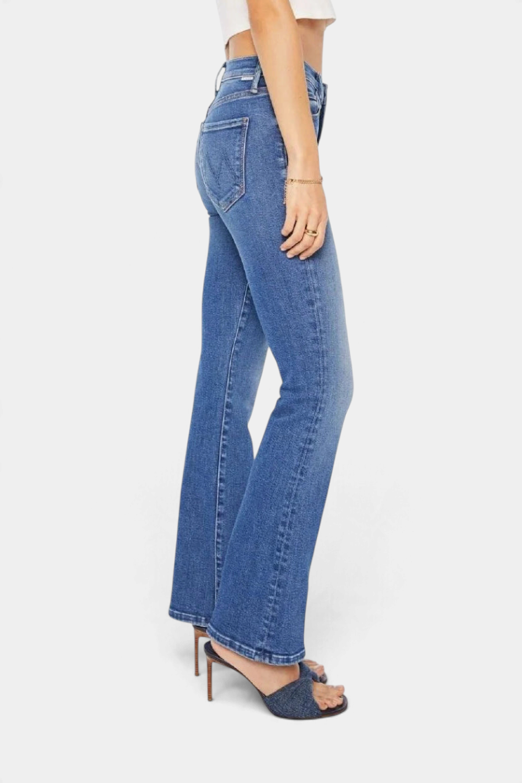 The Copper Shed The Outsider Skimp mid-rise flare jeans in mid-blue stretch denim with whiskering and a clean hem.