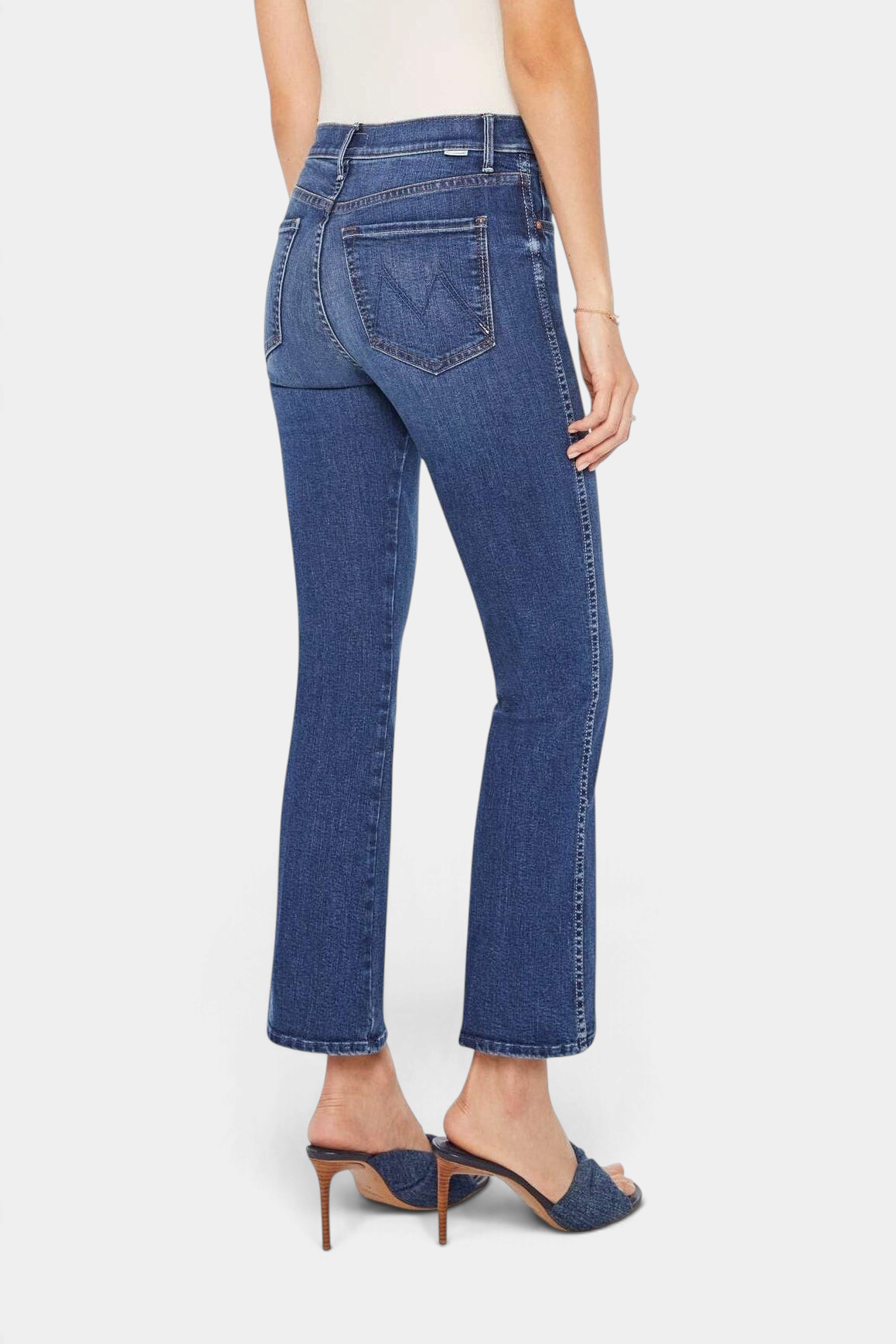 The Copper Shed mid-rise dark blue stretch denim jeans with a flared leg and clean hem, back view