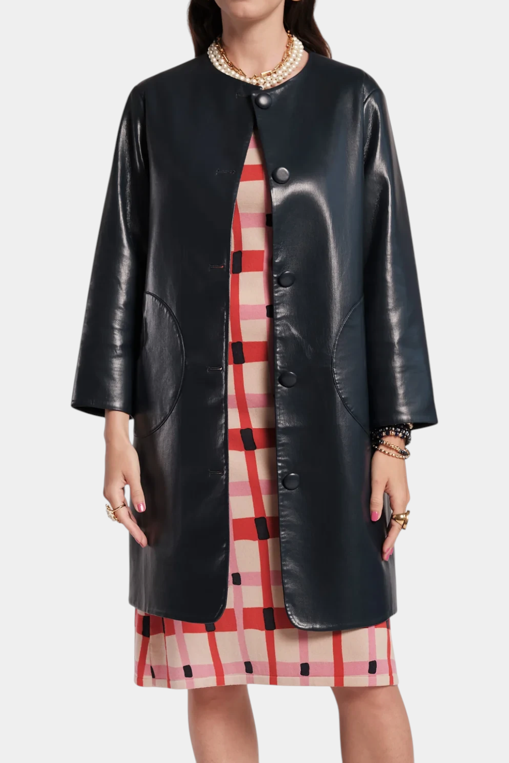 The Copper Shed Mod Jacket in black faux leather with a round collar, covered buttons, and circular front pockets.