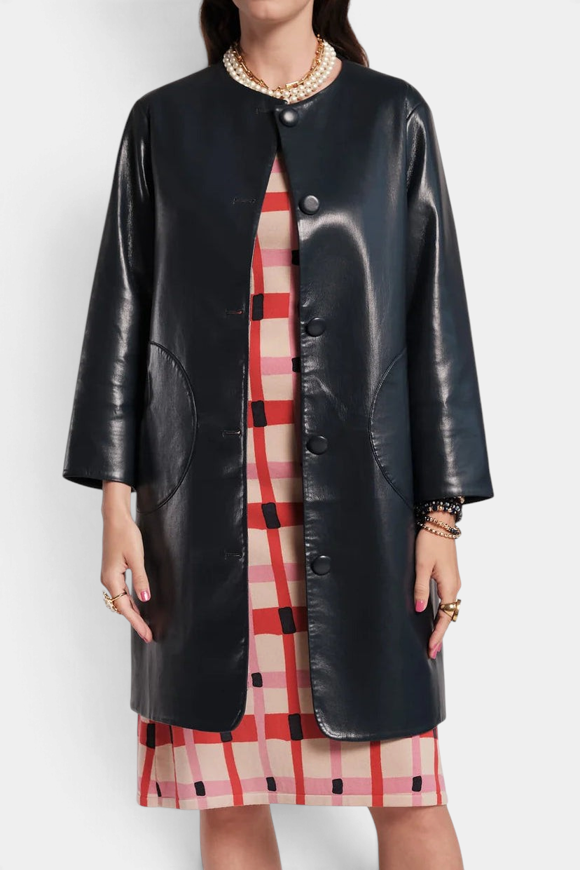 The Copper Shed Mod Jacket in black faux leather featuring a round collar, covered buttons, and circular pockets.