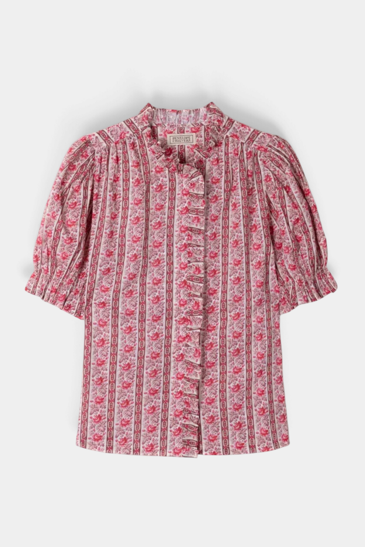 The Copper Shed Monday Prairie Blouse in pink floral cotton dobby with ruffled trim and puff sleeves.