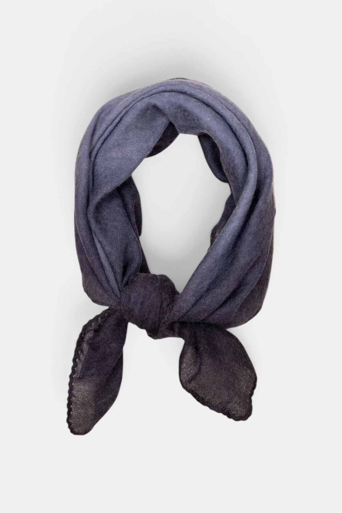 The Copper Shed Muse cashmere foulard in dark grey with a hand-stitched edge, styled in a simple neck knot.