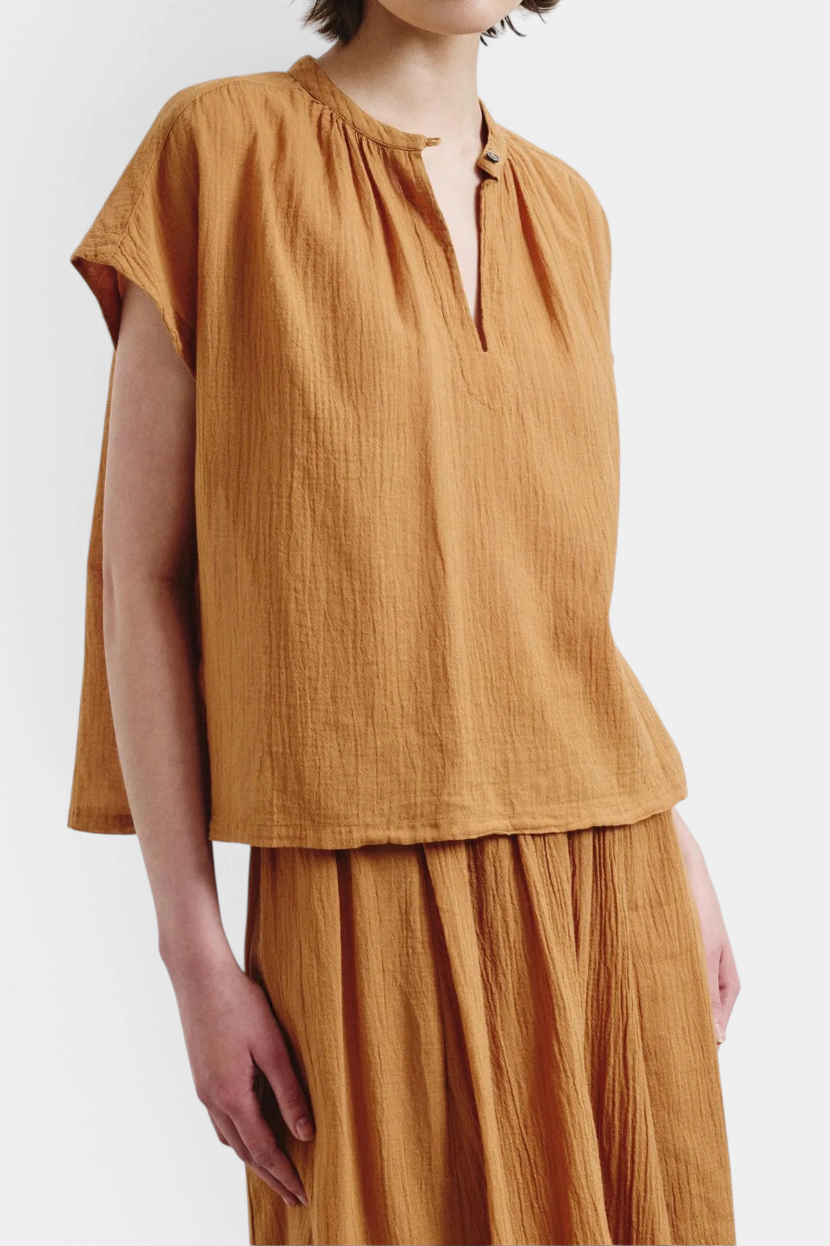 The Copper Shed organic cotton crepe gauze top in amber with a split neckline and relaxed sleeveless fit.