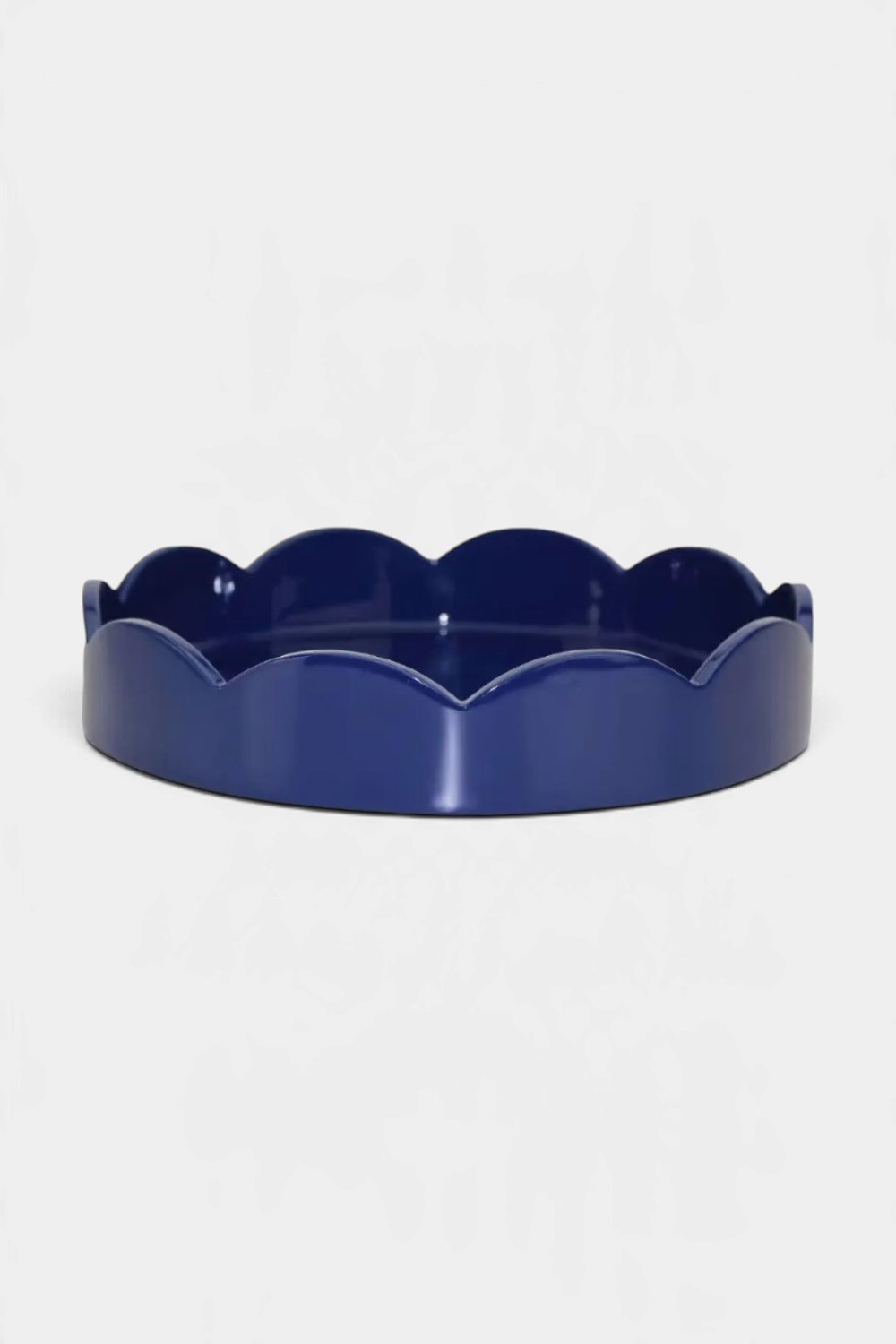 The Copper Shed round scallop tray in high gloss navy blue lacquer with a smooth hand-polished finish.