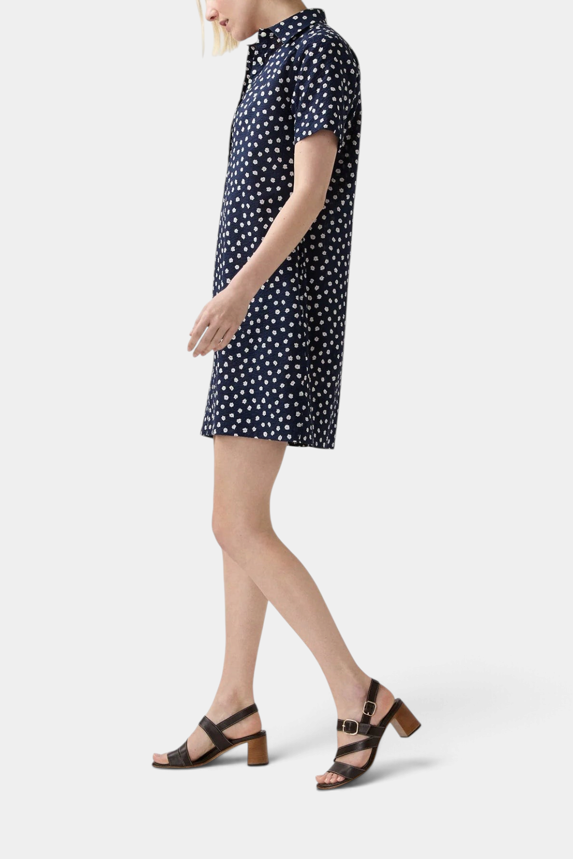 The Copper Shed short-sleeved navy blue crinkle cotton popover dress with a white daisy floral print, side view