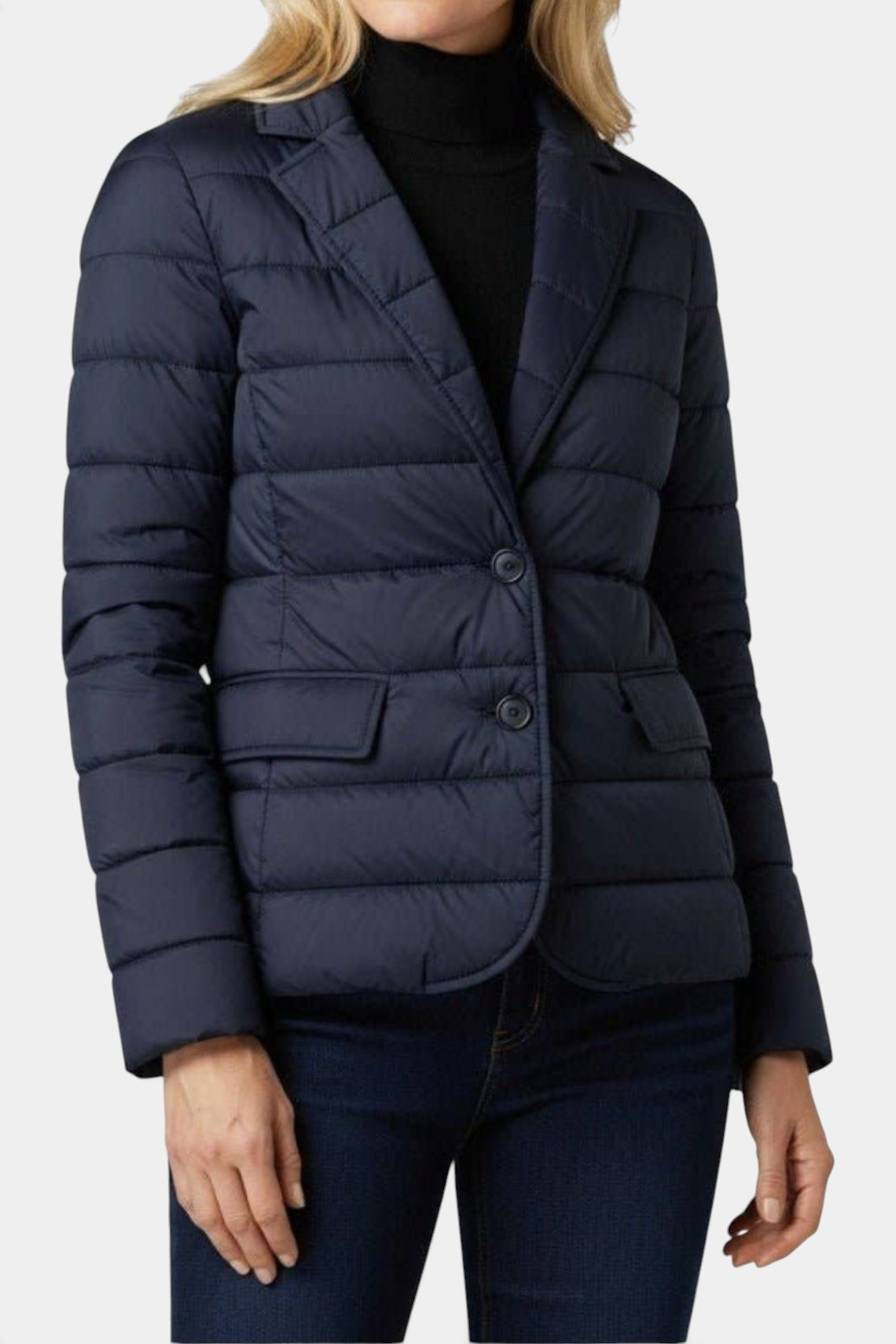 The Copper Shed navy blue quilted down blazer with notched lapels and button front closure worn by a woman.