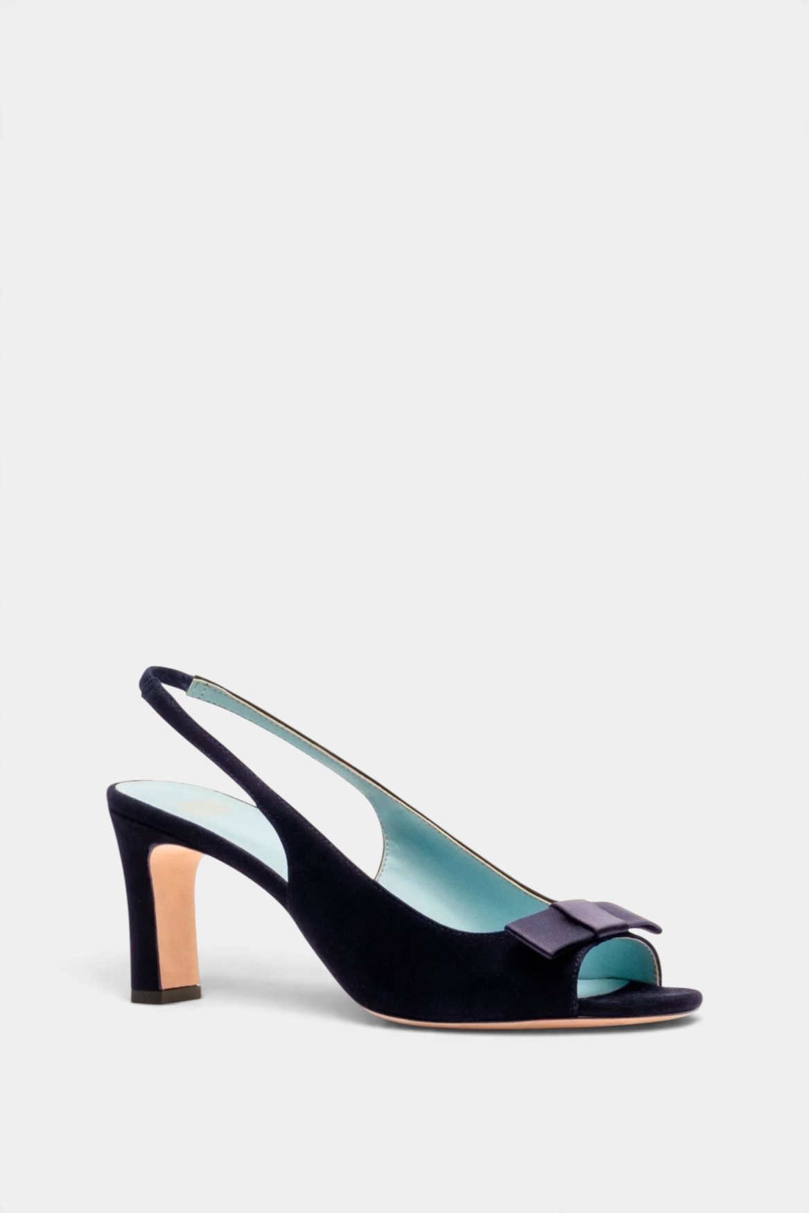 The Copper Shed navy suede Reese slingback heel with an open toe, ankle strap, and decorative bow on the vamp.