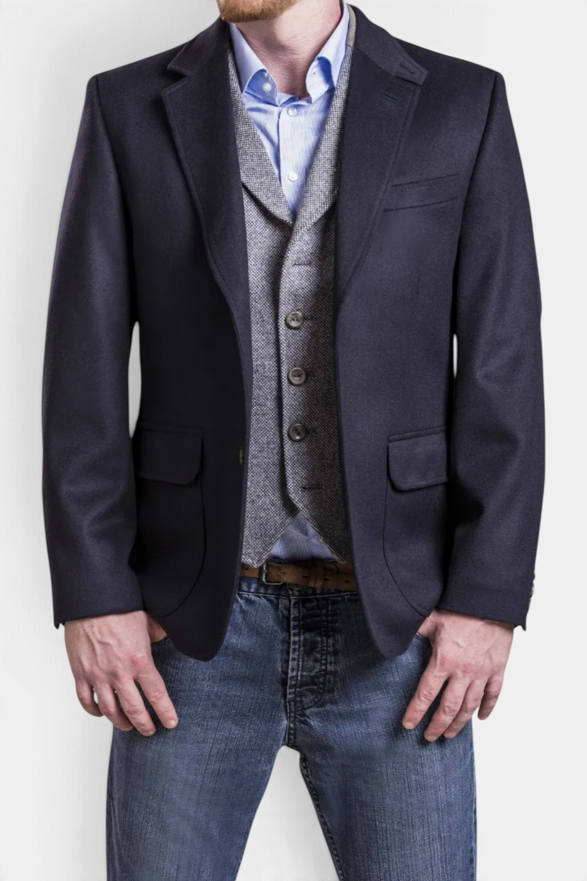 The Copper Shed Wilfred navy blue wool and alpaca blazer worn over a grey waistcoat and light blue shirt.