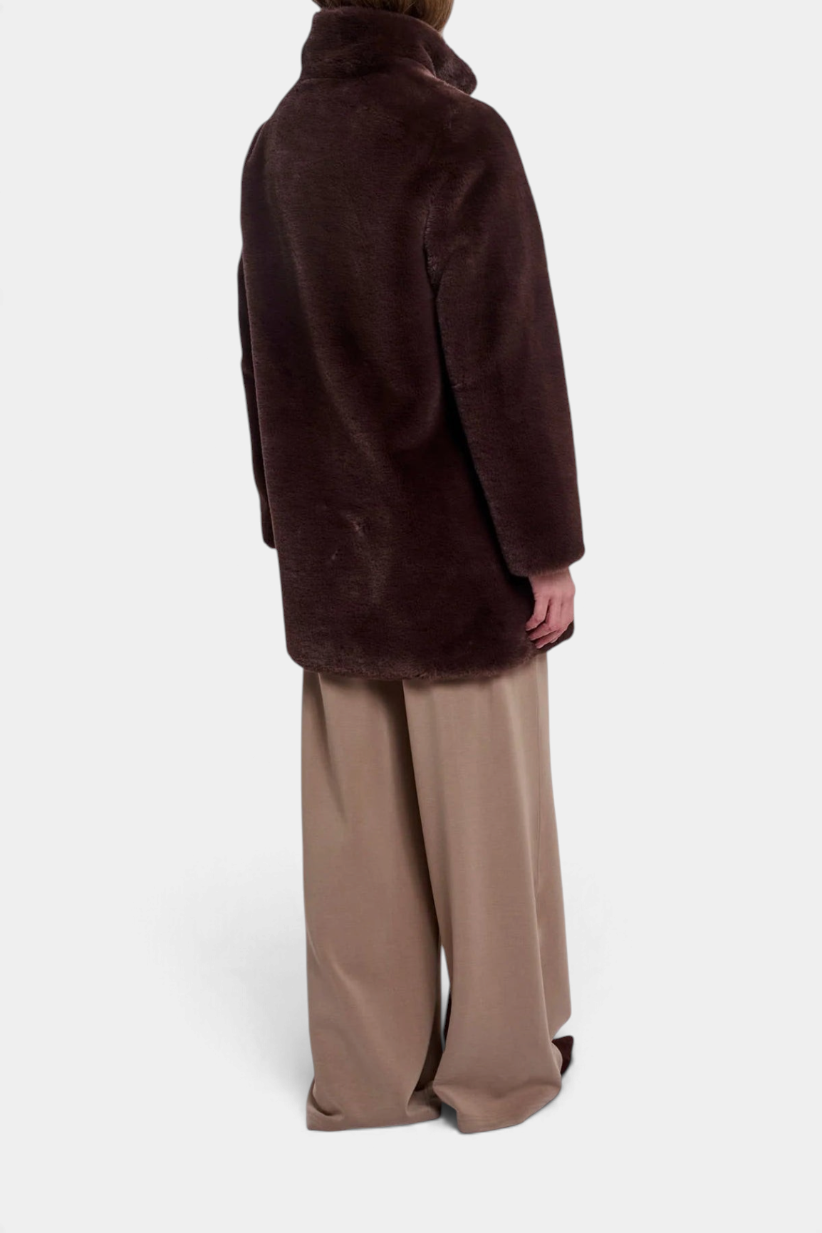 The Copper Shed Nonna coat in dark brown faux fur with a high-neck collar, shown from the back on a model.