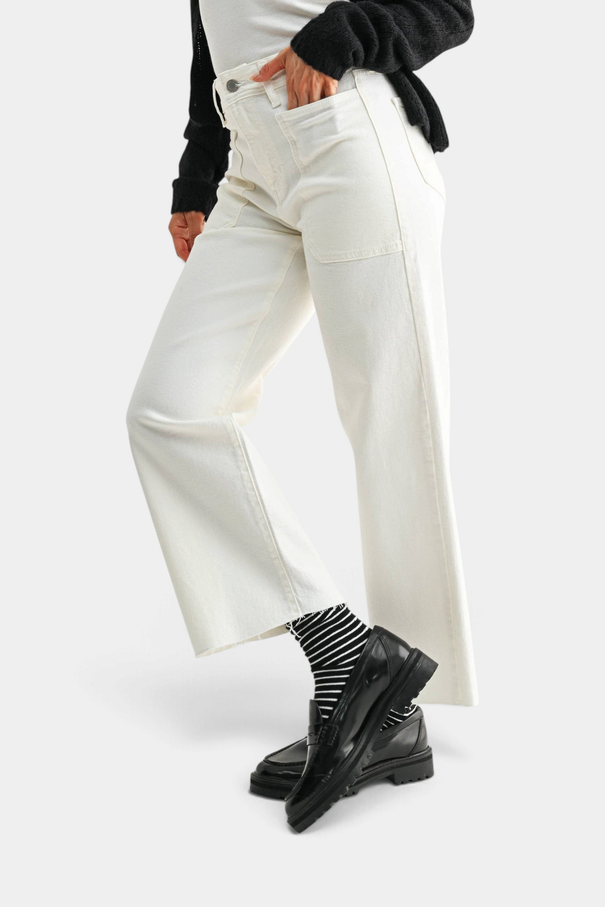The Copper Shed off-white high rise utility wide leg jeans with large front pockets, styled with black loafers.